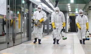 Công nhân mặc đồ bảo hộ phun thuốc khử trùng một nhà ga ở thủ đô Seoul của Hàn Quốc hôm 28/2. Ảnh: AFP.